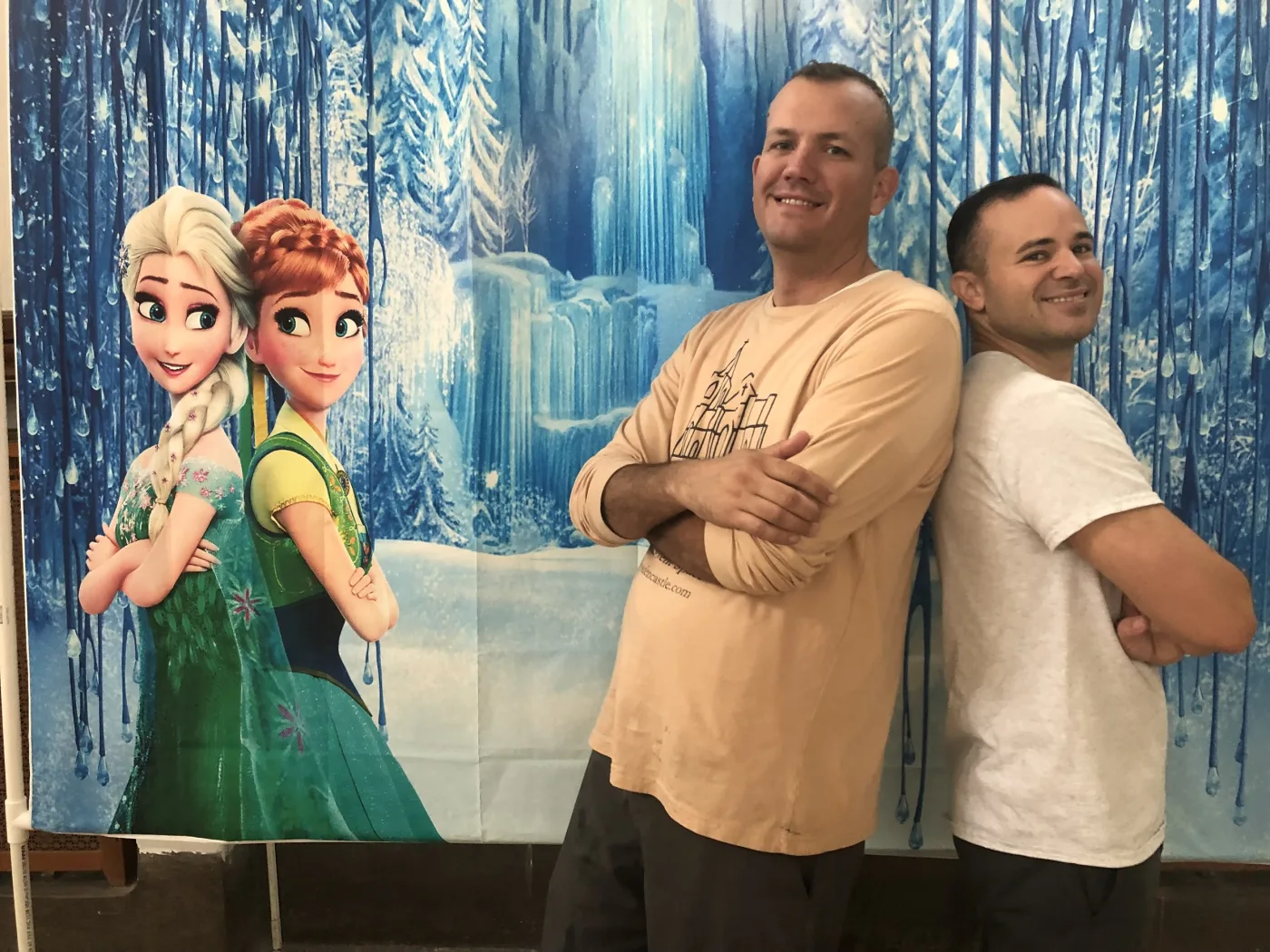Alex and Jason posing at a Frozen themed event backdrop