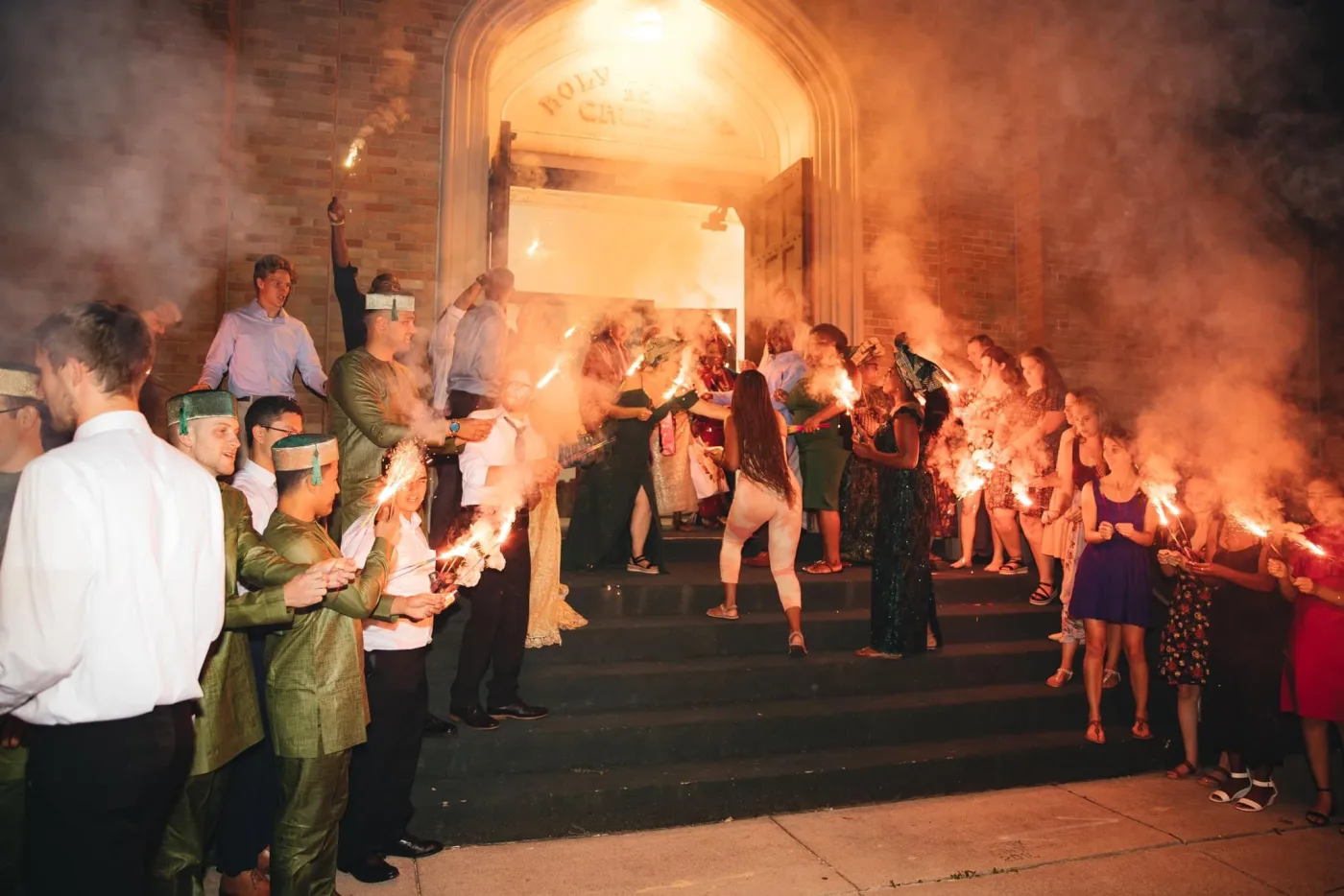 A couple's sparkler send-off on the church steps